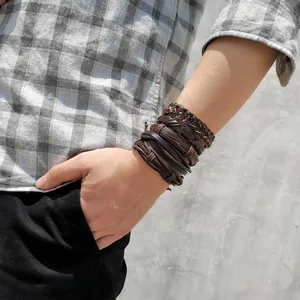 Detailed view of layered men's leather bracelet set with woven cords and adjustable straps