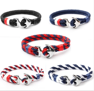 Detail showing five braided rope bracelets with various color patterns and metal anchor clasps