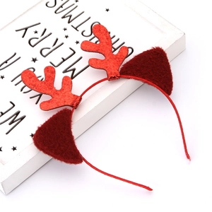 Close-up of a Christmas reindeer headband with bright red glitter antlers and plush ears