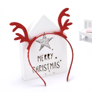 Close-up of red glitter reindeer antler headband on decorative Merry Christmas prop