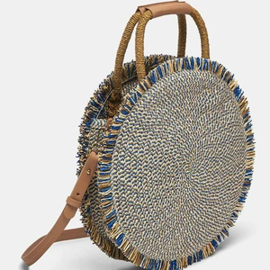 Handcrafted round straw beach bag with blue tassels and premium brown leather straps