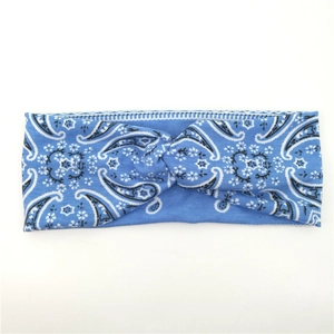 Detailed view of blue paisley knit headband with twist knot design for yoga and sports