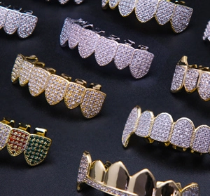 Macro detail of various hip hop teeth grillz in gold, silver and iced out diamond finishes