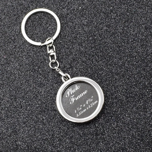 Close-up of heart-shaped silver photo frame keychain with dimensions 3.35cm x 3.75cm