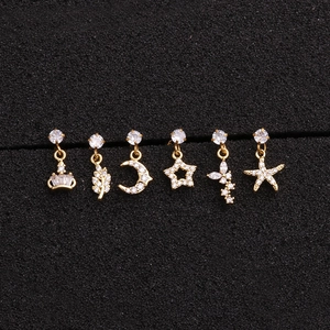 Detailed view of six gold-plated stud earrings featuring crown star and feather designs