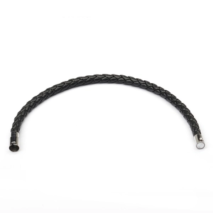 Detail of multi-strand black woven leather rope bracelet with silver magnetic buckle