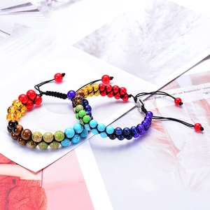 Two layers of colorful natural stone chakra beads woven on adjustable black braided bracelets