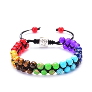 Detail of seven chakra stone double-layer braided bracelet with silver Tree of Life charm