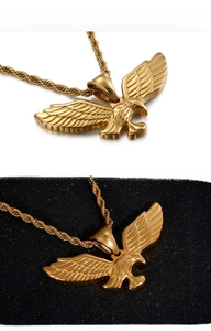 Detailed view of a gold eagle pendant with a robust rope chain on dual backgrounds