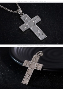 Detailed view of silver stainless steel cross pendant with geometric texture and twist chain