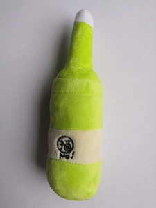 Detail of plush bottle dog toy in green with No embroidery on smooth gray background