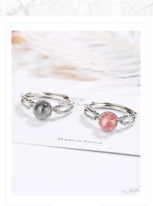 Detail showing two silver rings set with pink and grey round crystals and small diamonds
