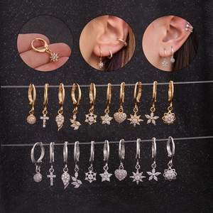 Detail shot of assorted gold and silver sun flower ear studs with sparkling cubic zirconia