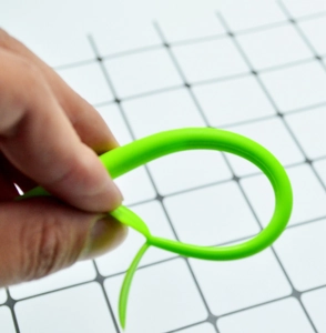 Macro shot showing the high flexibility and elasticity of the green silicone clover stem