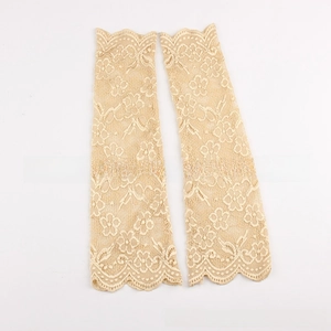 Detailed view of beige lace arm sleeves featuring floral embroidery and scalloped edges