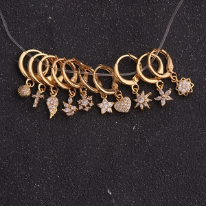 Golden sunflower zircon earrings collection with star and heart charms on black background