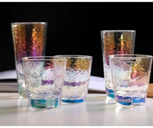 Macro shot of colorful hammered texture crystal glass cups with gradient rainbow finish