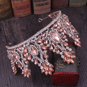 Detail of rose gold crown with champagne rhinestones on a vintage wooden background