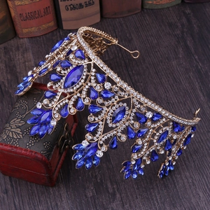 Close-up of golden princess crown with deep blue gemstones and sparkling crystals