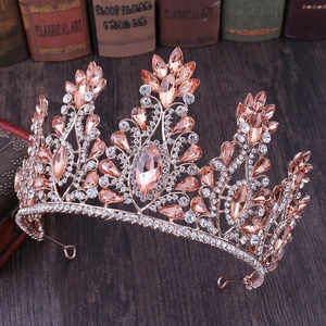Close-up of a rose gold bridal crown with peach marquise crystals and sparkling rhinestones