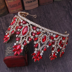 Detailed macro view of vintage bridal crown with vibrant red crystals and alloy base
