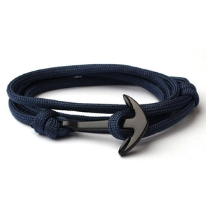 Close-up of navy blue multi-layer woven nylon cord bracelet with black metal anchor clasp