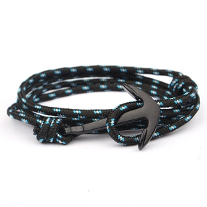 Close-up of black metal anchor clasp on black and blue braided nautical rope bracelet