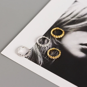 Close-up of S925 sterling silver hoop earrings with zircon paving and metal hallmark
