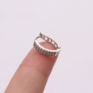 Silver cartilage huggie hoop earring with micro-pave cubic zirconia on fingertips