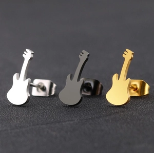 Detailed close-up of guitar-shaped stud earrings in silver, black and gold finishes