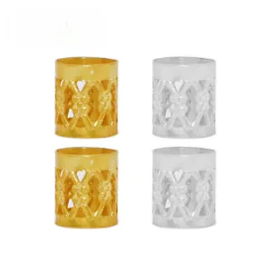 Close-up of gold and silver hollowed-out embossed metal dreadlock cuffs for hair extensions