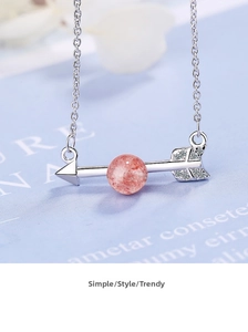Macro shot of silver arrow necklace with pink strawberry quartz and pavé zircon stones