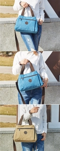 Outdoor lifestyle view of large canvas tote bag in blue and khaki with shoulder straps