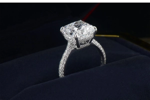Luxurious moissanite diamond ring with cushion cut center stone and pavé band in box