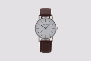 Front view of white minimalist watch face with blue hands and brown leather strap