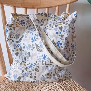 Detail of floral and deer print on white cotton tote bag for daily shopping