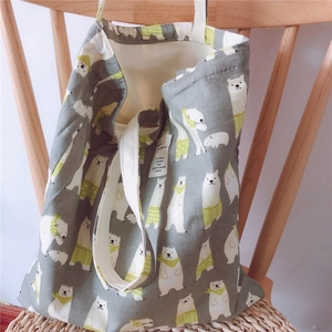 Detail of grey cotton tote bag showing cute polar bear print and thick canvas texture