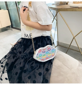 Kids colorful sequin lip shaped crossbody bag with gold chain strap worn by child