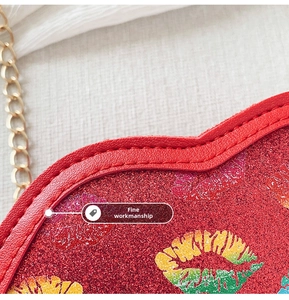 Detail of red glitter heart bag featuring colorful lip patterns and gold chain strap