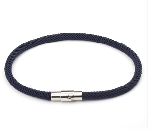 Close-up of deep blue braided rope bracelet featuring a polished magnetic metal clasp