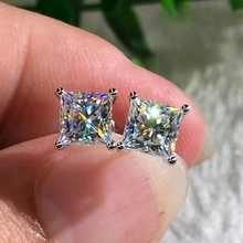 Macro detail of square-cut sparkling earrings featuring secure four-prong silver setting