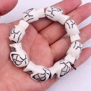 Punk style skull bead elastic bracelet made of faux yak bone for a hip hop look