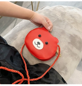 Close-up of red PU leather bear crossbody bag featuring orange strap and gold zipper