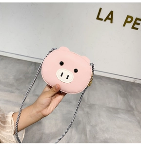 Detailed view of pink pig-shaped children's crossbody bag with woven chain strap