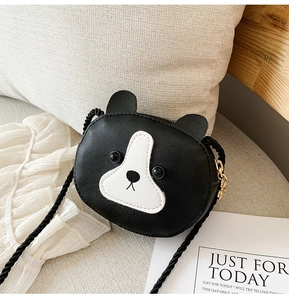 Close-up of dog-shaped PU leather child purse with woven strap and gold hardware