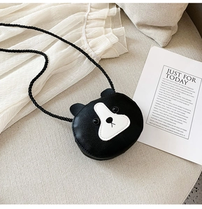Detail of cute bear-shaped PU leather crossbody bags on a sofa for children