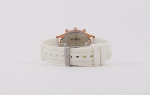 Detailed back view of white silicone watch strap with rose gold casing and silver buckle