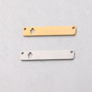 Detailed macro view of gold and silver rectangle stainless steel pendants with Hamsa cutouts