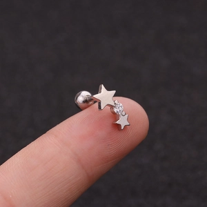 Close-up of silver double star ear stud with zircon and screw back ball closure