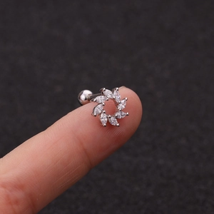 Sparkling zircon flower ear bone stud in silver stainless steel on a fingertip